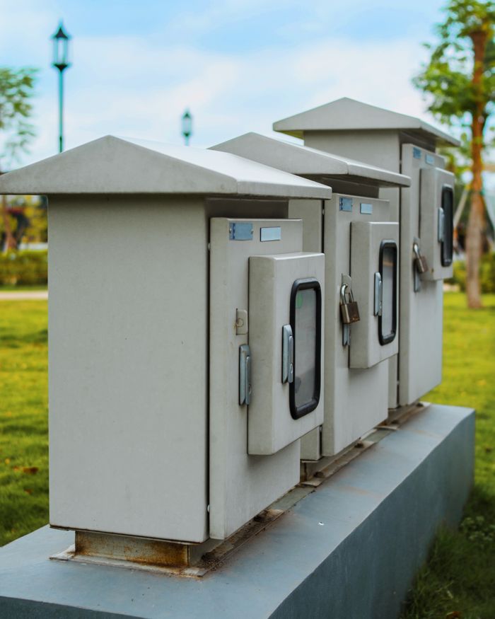 pexels photo 4089662 Close-up of locked electric boxes outdoors, featuring metal cabinets on a platform.